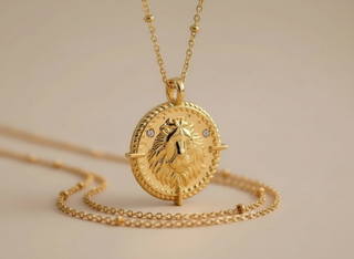 Leo zodiac necklace hanging in studio background