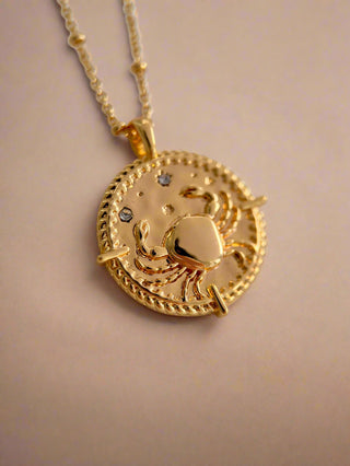18k gold plated brass Cancer star sign Zodiac Necklace with cubic zirconia stones and intricate detailing on a coin disc pendant and on fine ball chain.