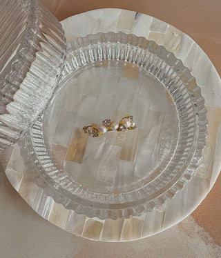 Freshwater Pearl Ring with pearls and cubic zirconia stones across a band ring in gold plating in a glass ribbed jewellery box on a mother of pearl dish from Zara Home.