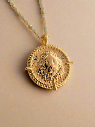 18k gold plated brass Leo Zodiac star sign Necklace with cubic zirconia stones and intricate detailing on a coin disc pendant and on fine ball chain.