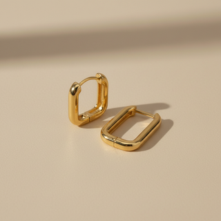 gold link hoops on beige background