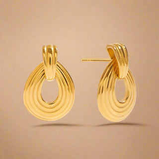 Gold hoop earrings on a white background