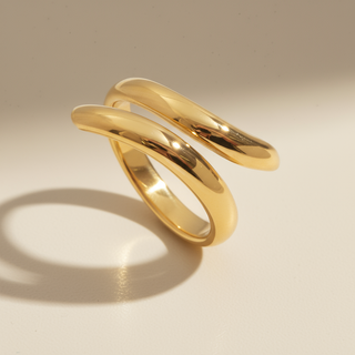 Gold spiral ring on a beige background
