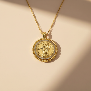 Gold coin necklace on a beige background