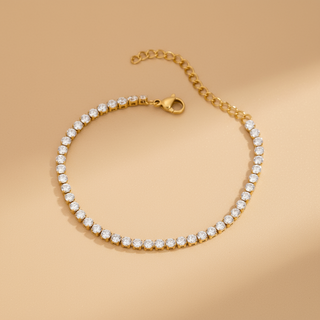 Gold bracelet with clear gemstones on a beige background