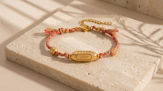 Bracelet with 'LUCKY' tag on a textured surface