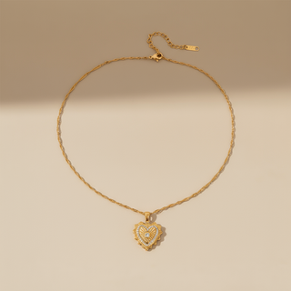 Gold necklace with a heart-shaped pendant on a beige background