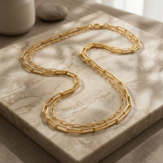 Gold chain necklace on a marble surface