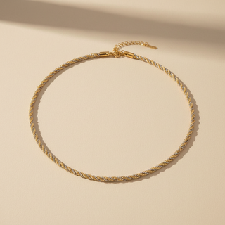 Gold necklace on a beige background