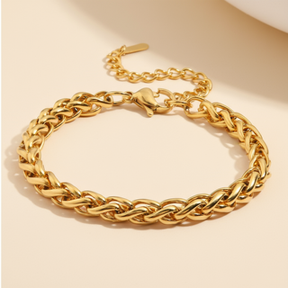 Gold chain bracelet on a beige background