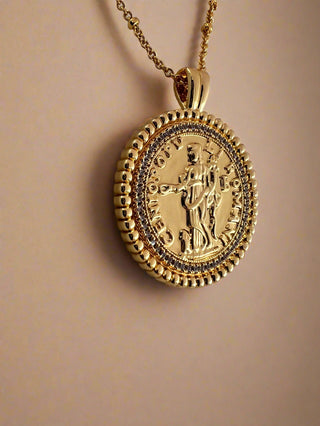 18k gold plated two coin necklace with cubic zirconia stones around the disc and an antique style roman man and roman letters around the edge of the coin.