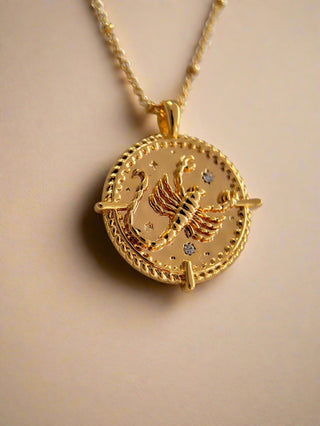 18k gold plated brass Scorpio star sign Zodiac Necklace with cubic zirconia stones and intricate detailing on a coin disc pendant and on fine ball chain.