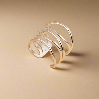 Silver ring with a unique design on a beige background