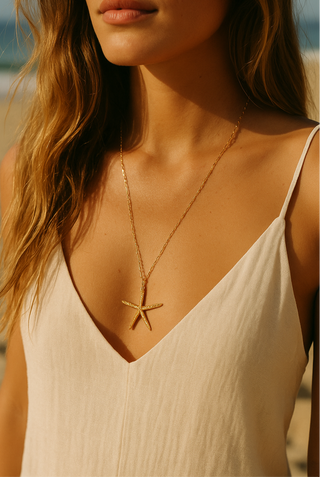 Woman wearing a starfish necklace on a beach