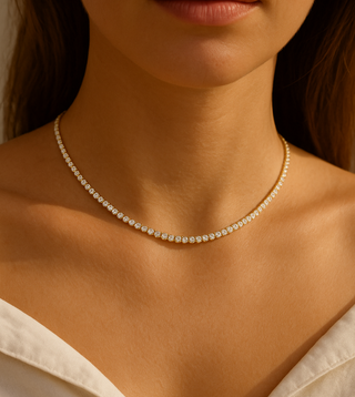 tennis necklace worn by a person with a neutral background